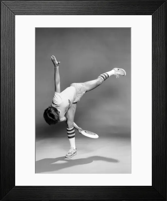 Framed Print : A man performing exercises with a frisbee. June 1980 Framed Print : A man performing exercises with a frisbee. June 1980