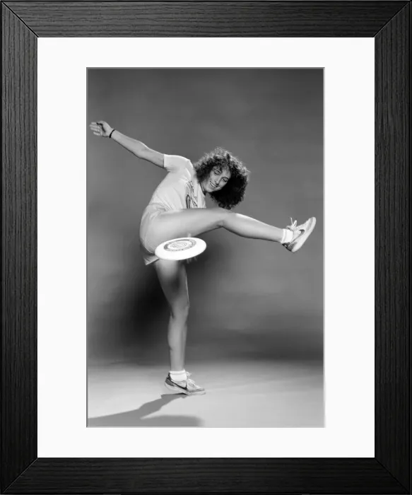 Framed Print : A woman performing exercises with a frisbee. June 1980 Framed Print : A woman performing exercises with a frisbee. June 1980