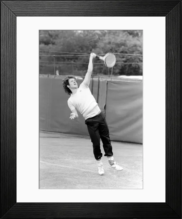Framed Print : John McEnroe, with a foot bandaged and leather support seen here during training running Framed Print : John McEnroe, with a foot bandaged and leather support seen here during training running