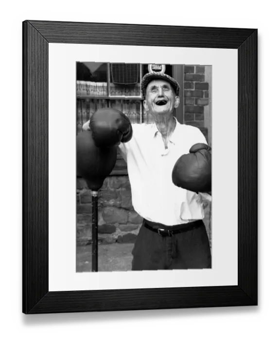 Framed Print : People - Old Man, Jackie McGuire, without any teeth wearing boxing gloves standing by a