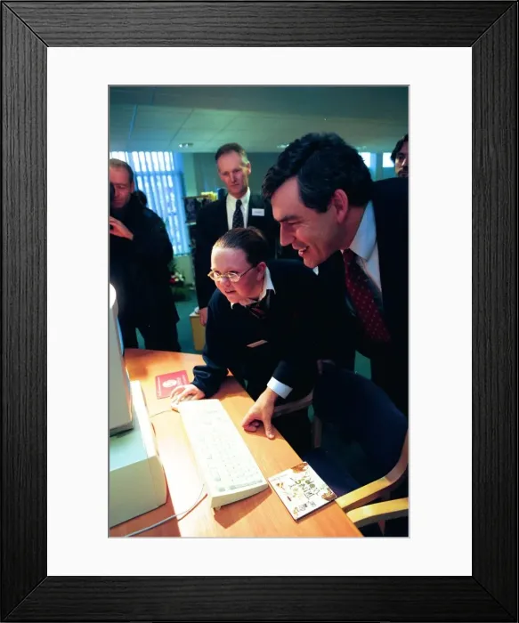 Framed Print : Gordon Brown is shown around the computer room at Benfield School by pupil Claire Framed Print : Gordon Brown is shown around the computer room at Benfield School by pupil Claire