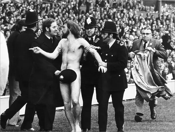 Streaker male nude naked man on pitch at Twickenham police cover him up with hat