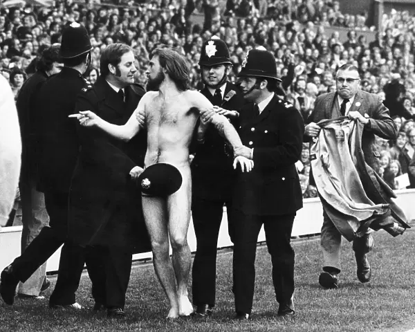 Streaker male nude naked man on pitch at Twickenham police cover him up with hat