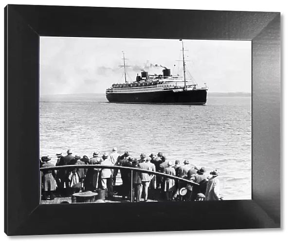 Crowds watch the ocean liner Bremen seen here in the Solent Circa 1936