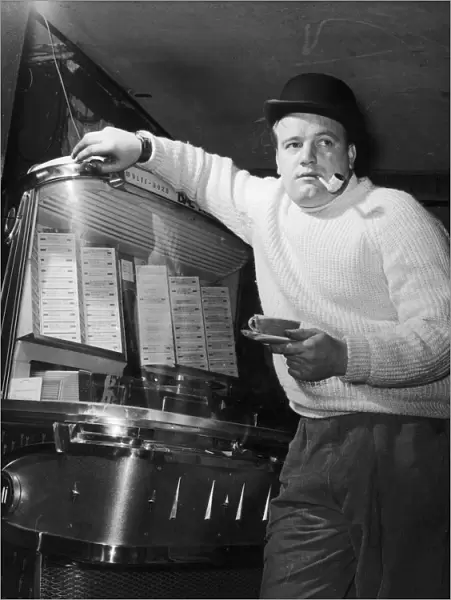 The owner of the Nucleus coffee bar David Dellamura, stands beside his juke box