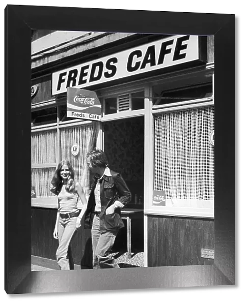 Young couple walking out of Freds cafe ineast London after finishing their lunch