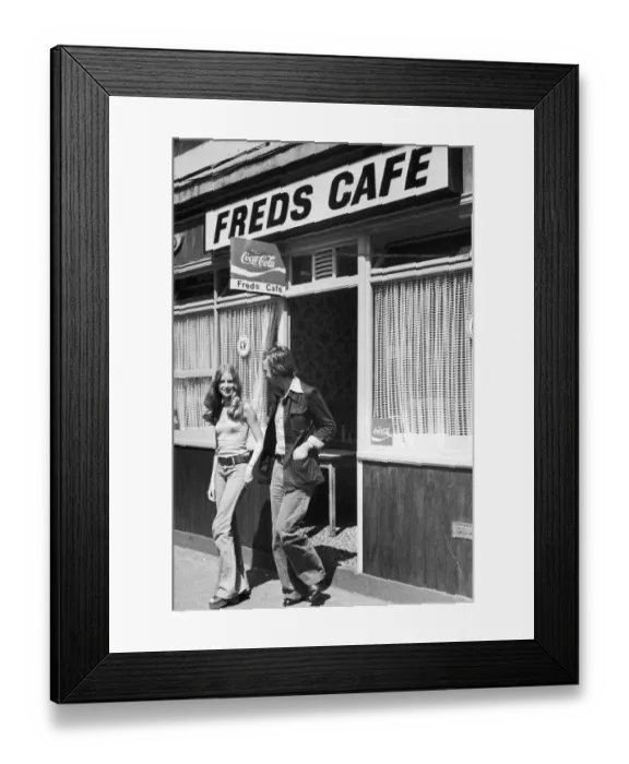 Framed Print : Young couple walking out of Freds cafe ineast London after finishing their lunch Framed Print : Young couple walking out of Freds cafe ineast London after finishing their lunch