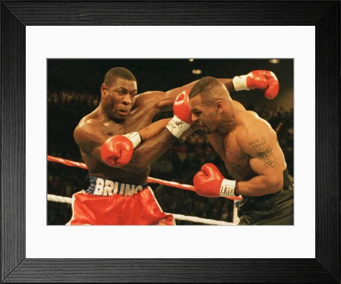 Framed Print : Mike Tyson launchers an attack on Frank Bruno during the WBC world title fight in Las Framed Print : Mike Tyson launchers an attack on Frank Bruno during the WBC world title fight in Las
