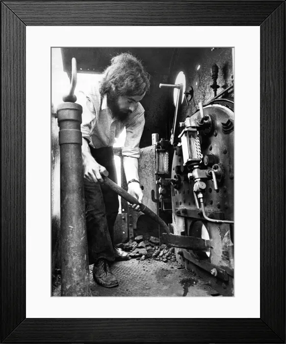 Framed Print : Fuel for the boiler of an old steam engine is shoveled on by Peter Weightman one of