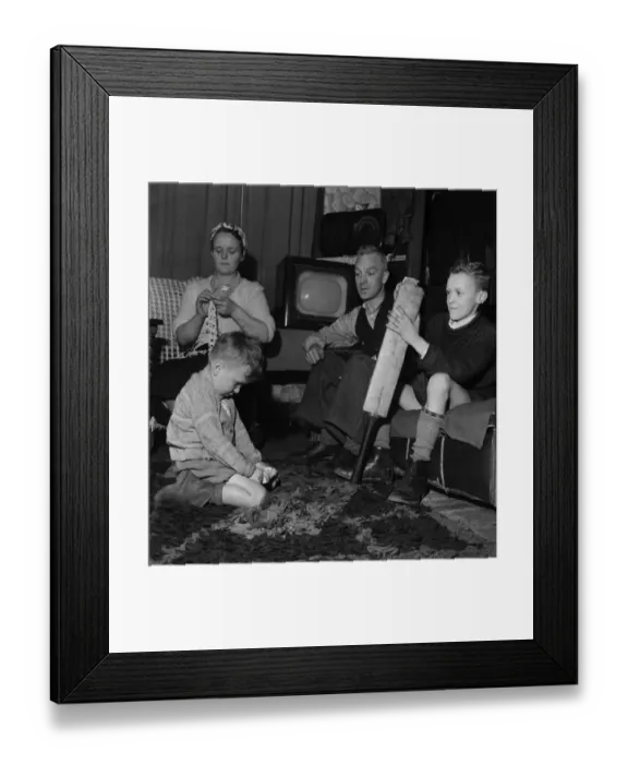 Framed Print : Family Life in Oldham 1952. Mother sews while father watch his youngest son play