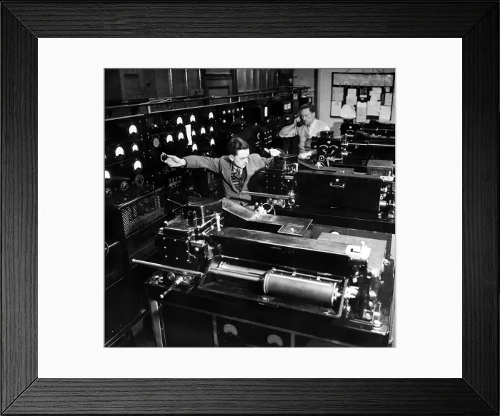 Framed Print : Technicians at work in the Telephoto room at the Daily Mirror Fetters Lane offices in