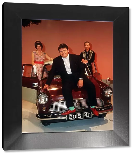 Robbie Coltrane actor pictured sitting on the bonnet of a mini Circa 1990