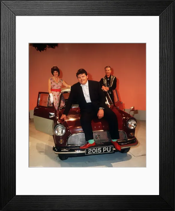 Framed Print : Robbie Coltrane actor pictured sitting on the bonnet of a mini Circa 1990 Framed Print : Robbie Coltrane actor pictured sitting on the bonnet of a mini Circa 1990