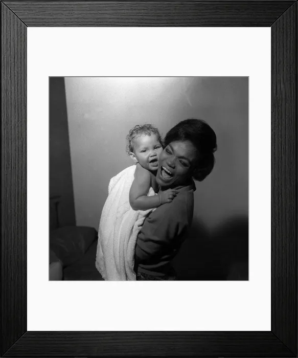 Framed Print : American singer and actress Eartha Kitt, photographed with her baby girl Kitt