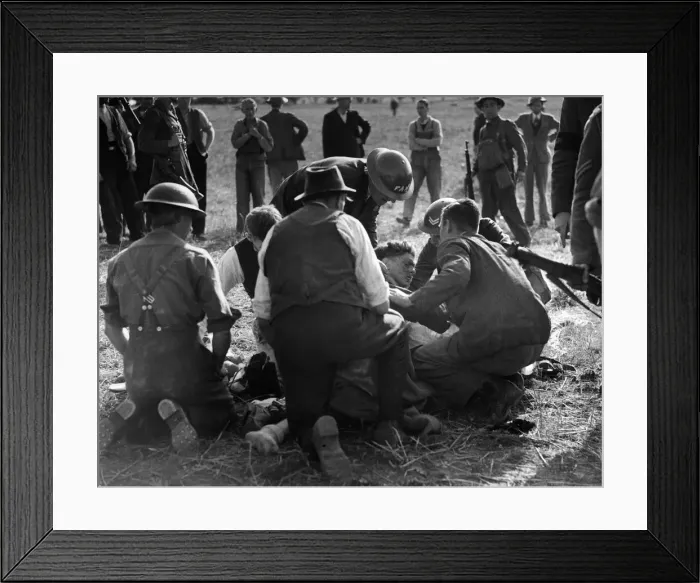 Framed Print : Army and FAP members attend to a German pilot in England who parachuted to the ground Framed Print : Army and FAP members attend to a German pilot in England who parachuted to the ground