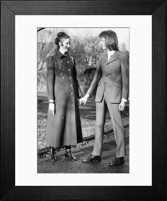 Framed Print : A young couple take a romantic stroll in the park