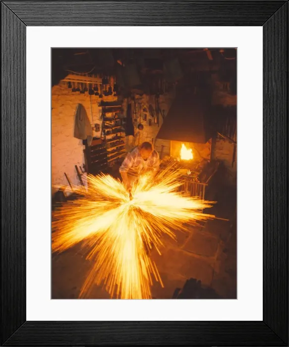 Framed Print : A blacksmith at work in a forge