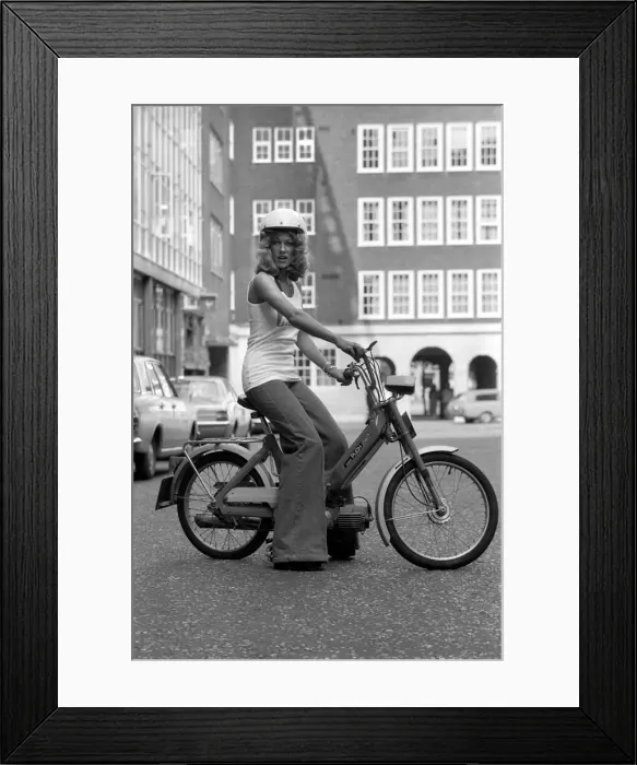 Framed Print : Publicity Dept: Girl on Bicycle. September 1975 75-04942-001