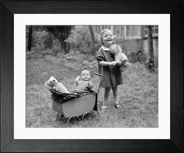 Framed Print : Small girl with doll pram buggy push chair Framed Print : Small girl with doll pram buggy push chair