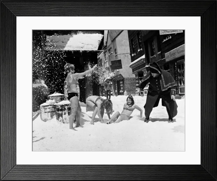 Framed Print : Filming of Oliver! at Shepperton studios. Three girls having a snowball fight with Harry