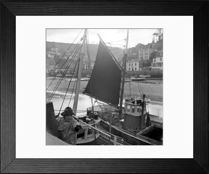 Framed Print : Fisherman ties his boat up in the harbour at Looe, Cornwall. D782-002 Circa 1953