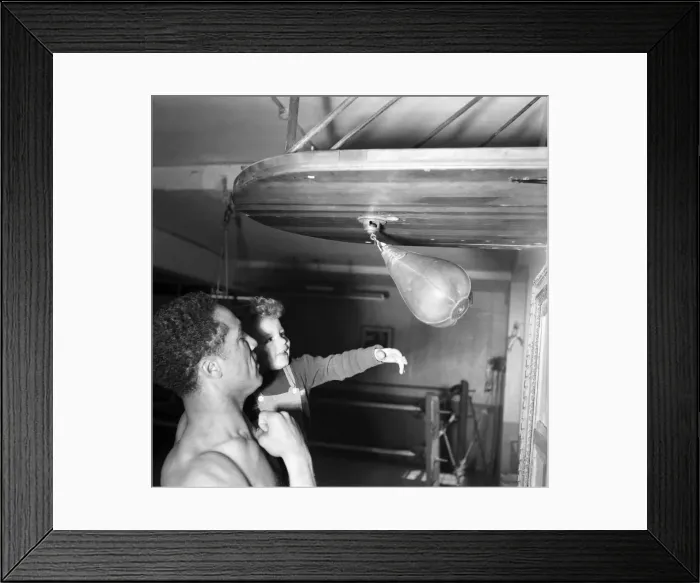 Framed Print : Boxing. Boxer Alex Buxton seen here holding his son Punching ball. May 1953 D2547