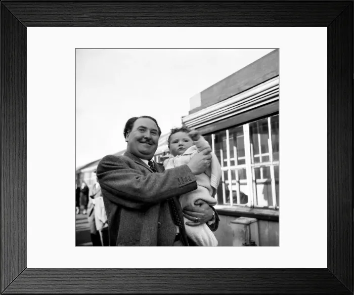 Framed Print : Joseph Locke, famous tenor helps his six month old son Prince, to wave goodbye to his mum Framed Print : Joseph Locke, famous tenor helps his six month old son Prince, to wave goodbye to his mum