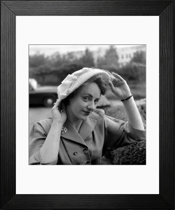 Framed Print : Hat Fashions 1953. Woman adjusts hat. May 1953 D2613 Framed Print : Hat Fashions 1953. Woman adjusts hat. May 1953 D2613