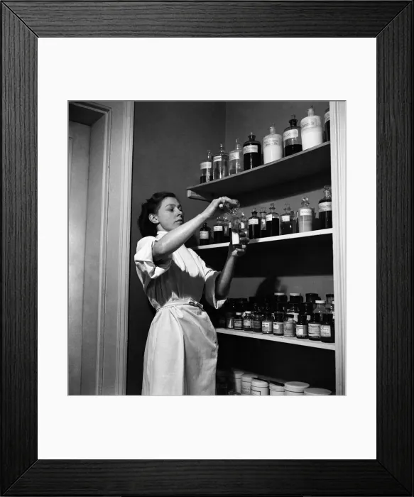 Framed Print : RSPCA Hospital. One of the nurse checks the medicine cabinet