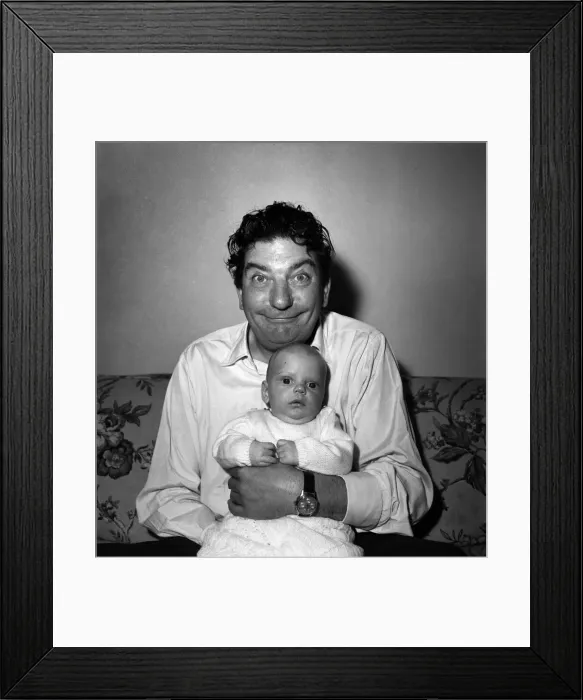 Framed Print : Sid Field with baby. September 1948 O14844