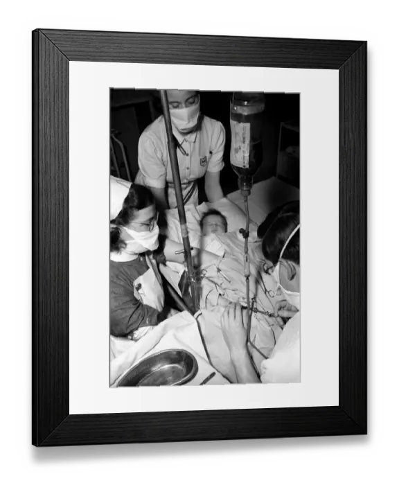 Framed Print : Hospital operation hearts. Babys life saved by blood transfusion. October 1946 O5112-001