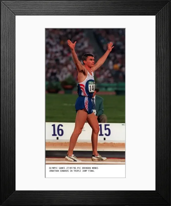 Framed Print : Jonathan Edwards during the triple jump in the Olympic Games in Atlanta where he won Framed Print : Jonathan Edwards during the triple jump in the Olympic Games in Atlanta where he won