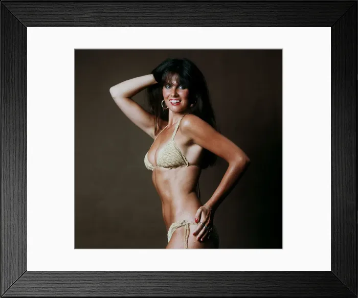 Framed Print : Actress Caroline Munro wearing gold bikini 1983 Played a James Bond girl in
