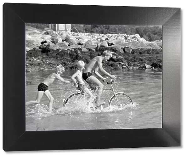 Arctic Summer in Northern Norway Children playing in the sea during one of