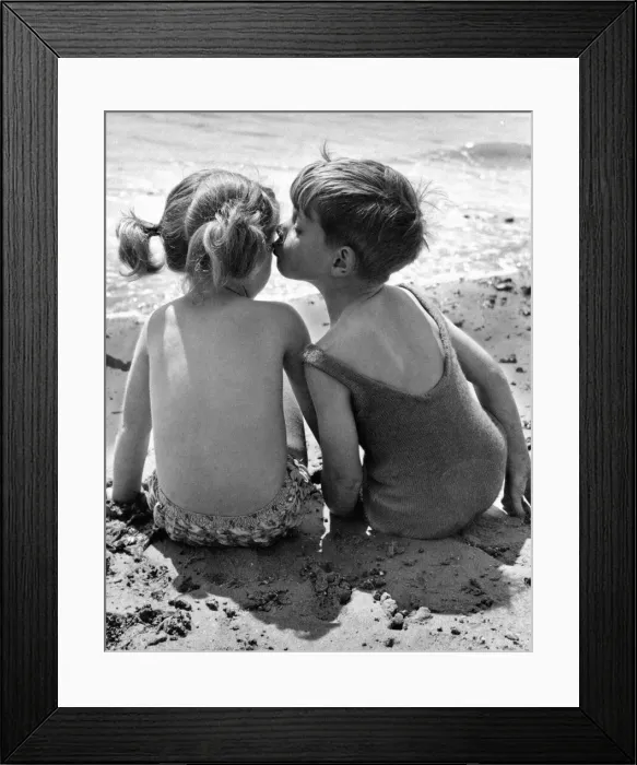Framed Print : A brotherly kiss on the cheek for his sister while the two children enjoy their summer