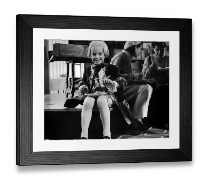 Framed Print : Seven year old Jeremy Atkin played some of Mozarts early works at a festival hall