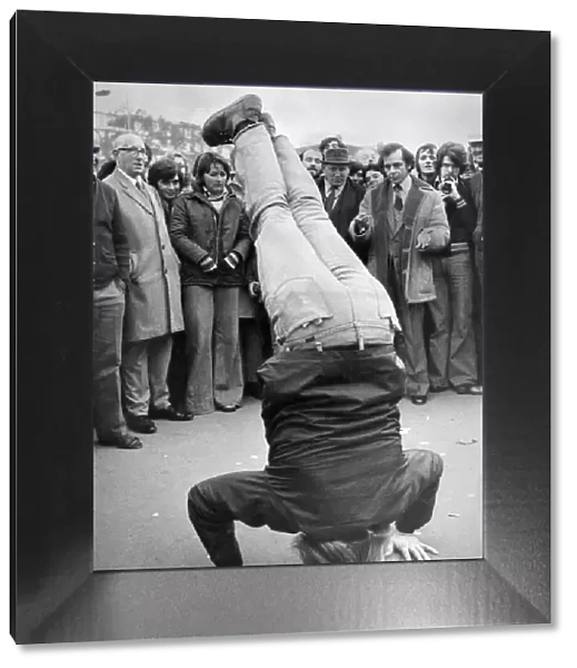 20 year old American student Tom Athmann stands on his head for the Speakers Corner