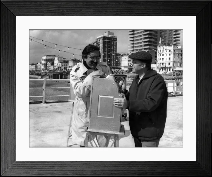 Framed Print : Director Richard Attenborough and producer-writer Len Deighton relax during a break in
