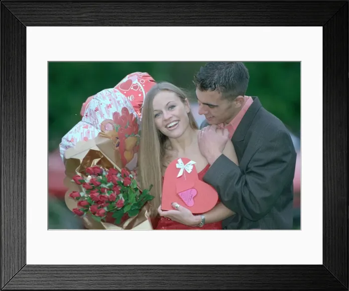 Framed Print : A man lavishes valentine gifts on his girlfriend