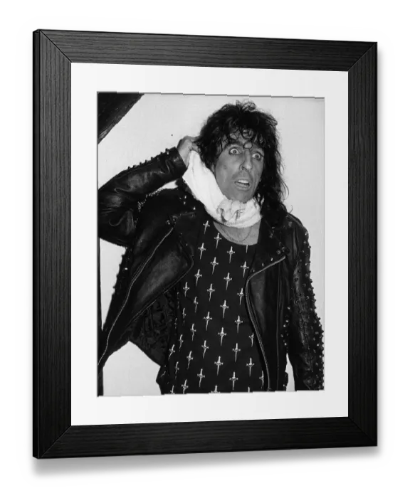 Framed Print : Alice Cooper American rock singer jokes after a stage stunt went wrong when doing a mock Framed Print : Alice Cooper American rock singer jokes after a stage stunt went wrong when doing a mock