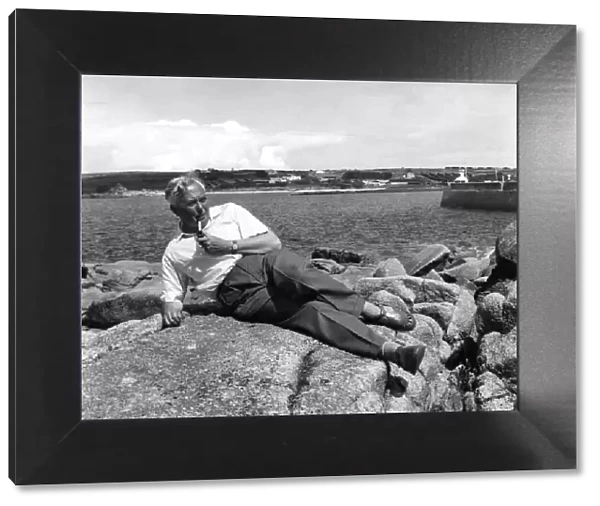 Leader of the Labour Party Harold Wilson, relaxes on the rocks at St
