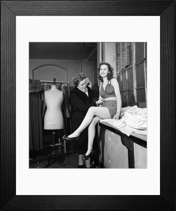 Framed Print : 17 year old girl being fitted with beachwear for the film Discovery