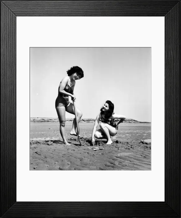 Framed Print : Models wearing the latest beachwear fashions digging. October 1952 C5081-001