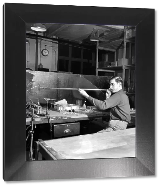 Glass blower Man blowing glass in his workshop. October 1952 C4910-001