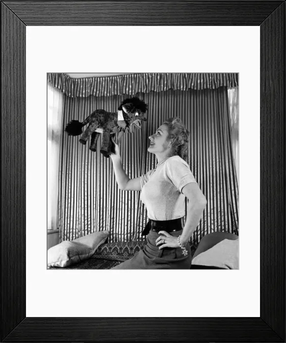 Framed Print : Lynne Breton. Woman with stuffed toy donkey. October 1952 C4870-002 Framed Print : Lynne Breton. Woman with stuffed toy donkey. October 1952 C4870-002