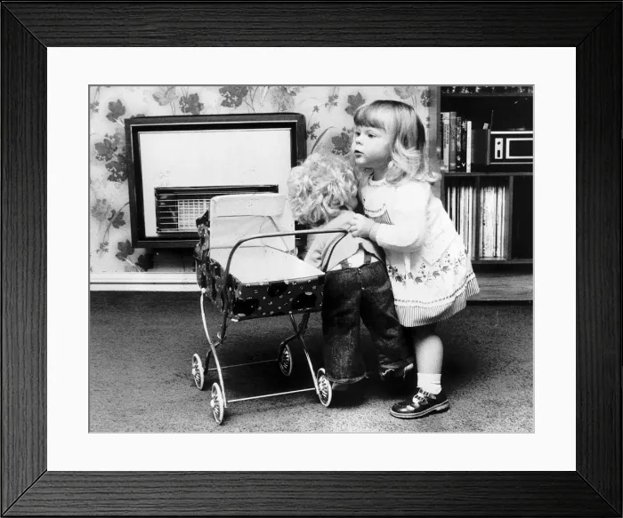 Framed Print : Louise Brown Test Tube Girl playing with doll and dolls pram June 1980