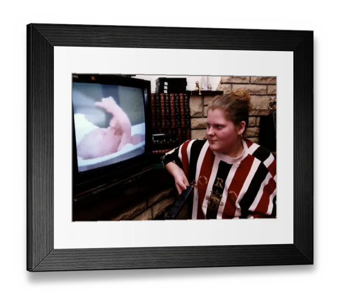 Framed Print : Louise Brown looking at video of herself as the worlds first test tube baby January Framed Print : Louise Brown looking at video of herself as the worlds first test tube baby January