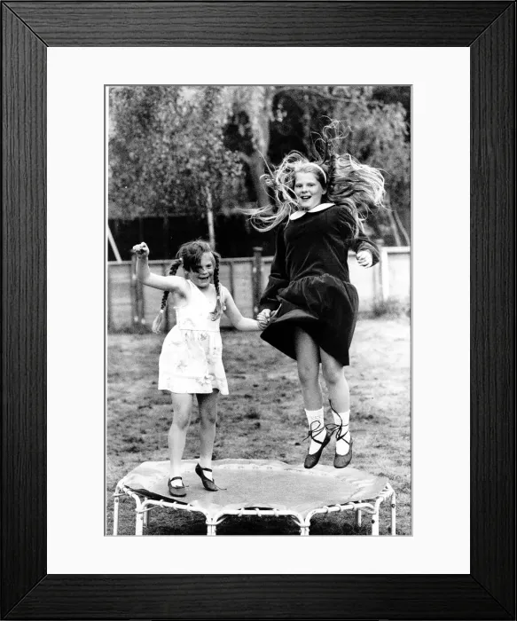 Framed Print : Louise Brown the worlds first test tube baby plays on a foot trampoline with her sister