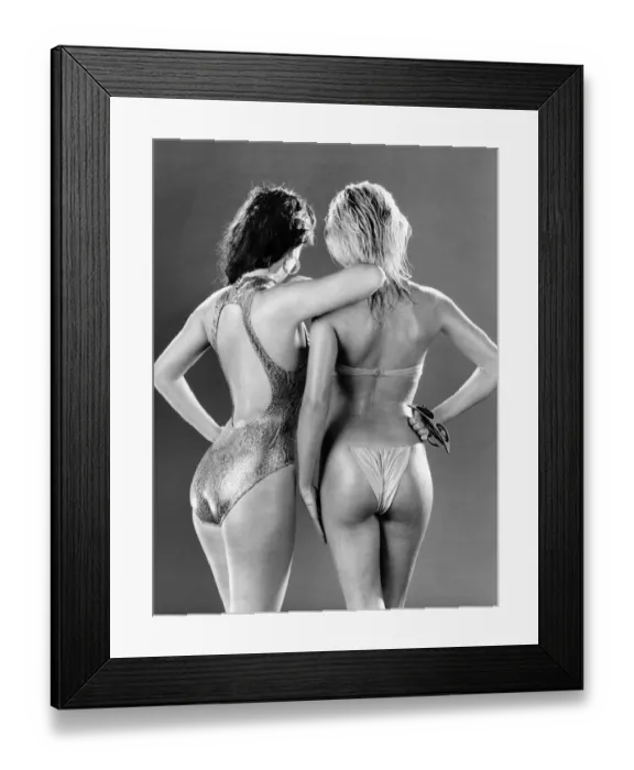 Framed Print : Clothing Beach - wear. Women standing with backs to camera wearing a shiny