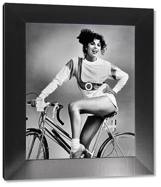 Fashion - Shorts and Hotpants. Short shorts and long sleeved top. Model sits on bicycle
